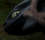 Toothless' eye is suddenly open, making him look both sinister and scared.