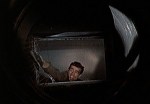 Bond breaks out of his cell through an air shaft.