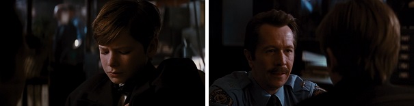 Sgt. Jim Gordon comforts Bruce Wayne after his parents are killed.