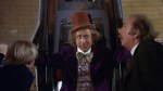 Willy Wonka lifts up Charlie and Grandpa Joe in his Great Glass Wonkavator.